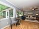 Bright living room with a dining area and large windows with views of the backyard at 4000 Chandworth Rd, Charlotte, NC 28210
