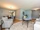 Inviting living room with hardwood floors, a large rug, and cozy grey seating arrangement at 4000 Chandworth Rd, Charlotte, NC 28210