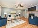 Cozy living room with hardwood floors, a ceiling fan, and a stone fireplace at 4000 Chandworth Rd, Charlotte, NC 28210