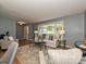 Bright living room featuring natural light, neutral walls, and an open view to front entry at 4000 Chandworth Rd, Charlotte, NC 28210