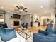 Cozy living room with fireplace and TV features hardwood floors and kitchen access at 4000 Chandworth Rd, Charlotte, NC 28210