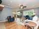 Open living area featuring hardwood floors, blue accent chairs, and kitchen access at 4000 Chandworth Rd, Charlotte, NC 28210