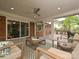 Covered porch featuring comfortable seating, a ceiling fan, and sliding door access to the backyard deck at 4000 Chandworth Rd, Charlotte, NC 28210