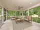 Screened porch featuring comfortable seating with a ceiling fan and views of the backyard at 4000 Chandworth Rd, Charlotte, NC 28210