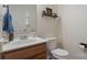 Cozy powder room with a decorative mirror, shelf, and fresh vanity at 4002 Paddle Wheel Ln, Indian Trail, NC 28079