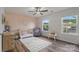 Cozy Bedroom featuring a crib, rocking chair, and plenty of natural light, creating a warm and inviting space at 4002 Paddle Wheel Ln, Indian Trail, NC 28079