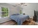 Bright bedroom with natural light, ceiling fan, and wood floors at 4002 Paddle Wheel Ln, Indian Trail, NC 28079