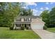 Charming two-story home with a well-manicured lawn and a cozy front porch at 4002 Paddle Wheel Ln, Indian Trail, NC 28079