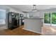 Bright kitchen featuring white cabinets, modern appliances, and an adjacent breakfast bar at 4002 Paddle Wheel Ln, Indian Trail, NC 28079