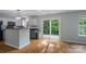 Open-concept kitchen with stainless appliances, natural light, and access to outdoor patio at 4002 Paddle Wheel Ln, Indian Trail, NC 28079