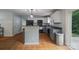 Well-lit kitchen featuring stainless steel appliances, white cabinets, and tiled floors at 4002 Paddle Wheel Ln, Indian Trail, NC 28079