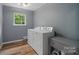 Functional laundry area with washer, dryer, and a storage cabinet at 4002 Paddle Wheel Ln, Indian Trail, NC 28079
