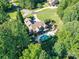 Aerial view of a secluded waterfront home with a pool, lush landscaping, and mature trees at 4290 Barbrick St, Sherrills Ford, NC 28673