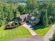 Expansive aerial view of a grand estate featuring a manicured lawn, lush greenery, lake, and a swimming pool at 4290 Barbrick St, Sherrills Ford, NC 28673