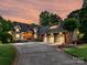 Charming home features lush landscaping, a circular driveway, and a spacious three-car garage at 4290 Barbrick St, Sherrills Ford, NC 28673