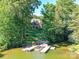 Lakefront home with a dock, lush landscaping, and a serene view of the water at 4290 Barbrick St, Sherrills Ford, NC 28673