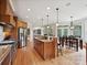 Open kitchen with stainless steel appliances, center island, breakfast bar, and a dining area at 4290 Barbrick St, Sherrills Ford, NC 28673