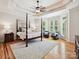 Spacious primary bedroom with tray ceiling, hardwood floors, and a sitting area near bright windows at 4290 Barbrick St, Sherrills Ford, NC 28673