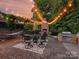 Outdoor kitchen with grill, dining and fireplace under string lights, perfect for backyard gatherings at 4290 Barbrick St, Sherrills Ford, NC 28673