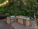 Outdoor kitchen featuring stone accents, a grill, sink, and refrigerator, perfect for entertaining guests at 4290 Barbrick St, Sherrills Ford, NC 28673