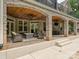 Comfortable covered outdoor brick patio featuring a seating area, brick arches, and wood ceiling with fans at 4290 Barbrick St, Sherrills Ford, NC 28673