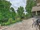 Patio and balcony featuring a black metal railing, an outdoor dining table and lush green vegetation at 4290 Barbrick St, Sherrills Ford, NC 28673