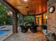 Charming patio area with a fire pit, comfortable seating, and brick pillars leading to the backyard and pool at 4290 Barbrick St, Sherrills Ford, NC 28673