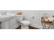 Bathroom featuring a pedestal sink, toilet, white ship lap walls, and decorative accessories on a side table at 435 Galbreath Ct # 128, Fort Mill, SC 29708