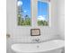 Close-up of a freestanding tub, showcasing elegant fixtures and bright natural light from the nearby windows at 435 Galbreath Ct # 128, Fort Mill, SC 29708