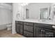 Modern bathroom with dual sinks, dark cabinetry and a neutral color palette, providing a functional space at 435 Galbreath Ct # 128, Fort Mill, SC 29708
