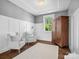 Bedroom featuring two armchairs, a soft rug, hardwood floors, and a view of the well-maintained yard through the window at 435 Galbreath Ct # 128, Fort Mill, SC 29708