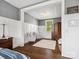 Comfortable bedroom featuring two armchairs, a soft rug, and a view of the well-maintained yard through the window at 435 Galbreath Ct # 128, Fort Mill, SC 29708