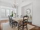 Bright dining room features hardwood floors, ship lap walls, and a large table with seating for eight at 435 Galbreath Ct # 128, Fort Mill, SC 29708