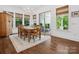 Sunlit dining room with wood floors, large table, and multiple windows at 435 Galbreath Ct # 128, Fort Mill, SC 29708