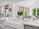 Bright kitchen features a farmhouse sink, white countertops, and stainless steel faucet at 435 Galbreath Ct # 128, Fort Mill, SC 29708
