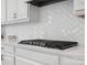 Close up of gas stove with decorative white backsplash and countertops at 435 Galbreath Ct # 128, Fort Mill, SC 29708