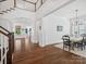 Open-concept living area featuring hardwood floors and high ceilings that seamlessly connects to the dining space at 435 Galbreath Ct # 128, Fort Mill, SC 29708