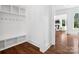 Mud room area boasts hardwood floors, built in shelving, and a glimpse into the bright and inviting living space at 435 Galbreath Ct # 128, Fort Mill, SC 29708