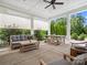 Charming patio space with comfortable seating, a wooden picnic table, and retractable screens for shade at 435 Galbreath Ct # 128, Fort Mill, SC 29708