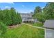 Spacious backyard featuring a well-maintained lawn, mature trees, and a deck perfect for outdoor enjoyment at 509 N Oak St, Lincolnton, NC 28092