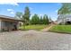 Large backyard with gravel area, a tool shed with covered patio and a stone walkway at 509 N Oak St, Lincolnton, NC 28092