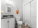 Cozy bathroom features a white vanity, toilet, and a linen closet at 509 N Oak St, Lincolnton, NC 28092