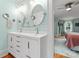 Bright bathroom with double vanity, mirrors and view into bedroom at 509 N Oak St, Lincolnton, NC 28092