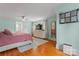 Bright bedroom with area rug, dresser, ceiling fan, and wood floors at 509 N Oak St, Lincolnton, NC 28092