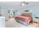 Bright bedroom with light blue walls, ceiling fan, area rug, and doorway to an exterior view at 509 N Oak St, Lincolnton, NC 28092