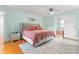Bright bedroom with a ceiling fan, area rug, stylish mirrors and a doorway to a bathroom at 509 N Oak St, Lincolnton, NC 28092
