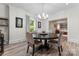 Elegant dining room featuring a round table, chandelier, and hardwood floors next to the living room at 509 N Oak St, Lincolnton, NC 28092