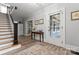 Inviting entryway featuring hardwood floors, a staircase, and an antique table underneath framed pictures at 509 N Oak St, Lincolnton, NC 28092