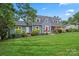 Charming blue two-story home boasts a beautifully landscaped front yard and inviting red door at 509 N Oak St, Lincolnton, NC 28092