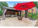 Cozy gazebo with fire pit, seating, red patio umbrella, and decorative wall at 509 N Oak St, Lincolnton, NC 28092